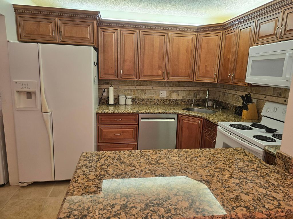 Photo of 317 Pine Ridge Circle, Greenacres, FL 33463 (MLS # B26013101)