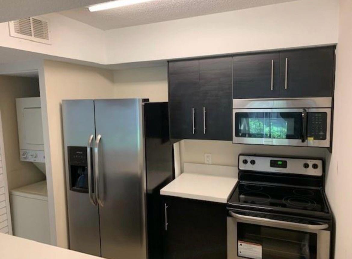 Stunning 1-bedroom, 1-bathroom condo featuring convenient in-unit washer and dryer, along with a cozy balcony offering tranquil canal views. Enjoy the comfort of tiled floors throughout. This gated community offers an array of amenities including tennis courts, a sparkling pool, and a well-equipped gym. Conveniently located near major shopping centers and highways, providing easy access to all essentials and beyond
