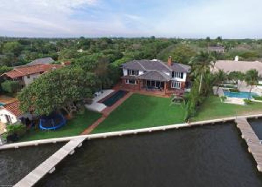 Newly renovated and meticulously cared for, this pristine 4 bedroom, 4.5 bath direct waterfront home with a boat lift and dock is now available for sale. Views for miles, the upstairs master bedroom and guest suite both personify Intracoastal living at its finest. Waking up every morning to glorious sunrises behind the Island of Palm Beach is just one of the many reasons to enjoy this peaceful and secluded estate.  Over the last 4 years, the current owners painstakingly renovated this home. The now eat-in 20' x 20' kitchen was gutted to the studs incorporating dual Miele dishwashers, extra large 36'' Miele fridge and separate 36'' Miele freezer with a Wolf gas stove and Sub Zero wine cooler.