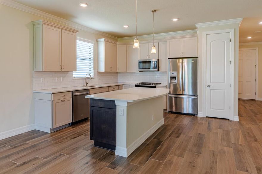 Live the dream in Veranda Gardens! This beautiful 4-bed, 3-bath gated community where every day feels like a vacation. Inside, elegance meets practicality. You'll love the gorgeous kitchen, open concept floor plan and the flow of the stylish wood-look tile plank floors. Primary Suite features dual sinks and built-in shelving in closet, large laundry room and garage storage. Enjoy your coffee or BBQ on the screened in lanai with lake view. This home offers worry-free living with impact windows. Veranda Gardens provides incredible amenities: Clubhouse resort like pool, lap pool, spa, cabanas, pickleball, tennis, basketball, fitness center, fire pit, dog park, tot lot, sidewalks and streetlights. Prime location near Turnpike, I-95, dining, shopping, and beaches. Schedule your showing today.