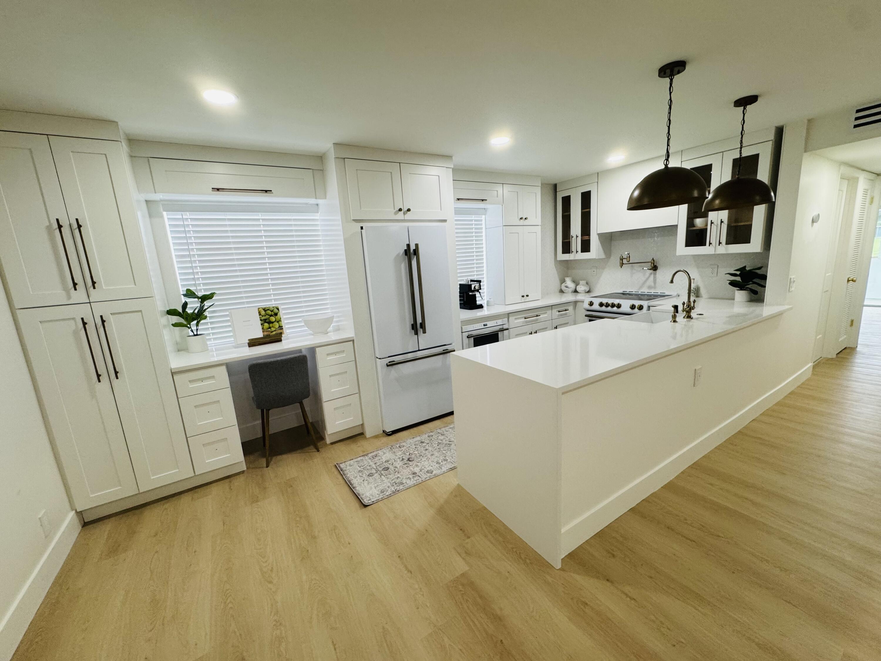 A few photos for a sneak peak - This upgraded designer unit will not last- FORNO appliances, Custom hood w Italian marble backsplash w Kingston Brass Pot filler and Kingston Brass faucet sprayer and air switch, Fireclay Apron sink, herringbone hand laid tile marble shower with floating vanities, privacy suite entrance, Nest thermostat w newer AC, new water heater and brand new Electrolux washer dryer.Impact Doors throughout.This unit also boasts lakefront and golf course views directly from your patio. More details to follow....