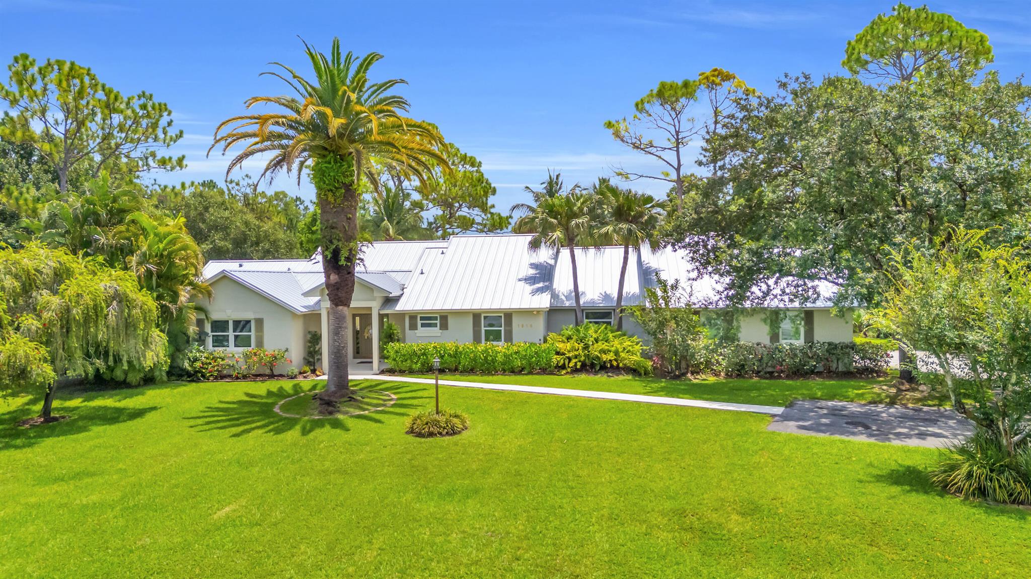 Jupiter's Best Value! Over an acre in Ranch Colony, overlooking the 10th green of the Dye Preserve in a 24 hour guard gated community. The pool and views are amazing! Privacy in both front and back. No membership required. Low HOA fees. HOA fees include Hot wire TV and Internet. Newer metal roof - 3 years old. Also skylights are impact and 3 years old. Some impact windows and or shutters.Salt pool with iAquaLink Application and Auto Fill. The fully fenced pool area is a tropical oasis on 1.21 acres. Water System is 3 years old. New tankless water heater, Whole house generator. 250 gallon propane tank.