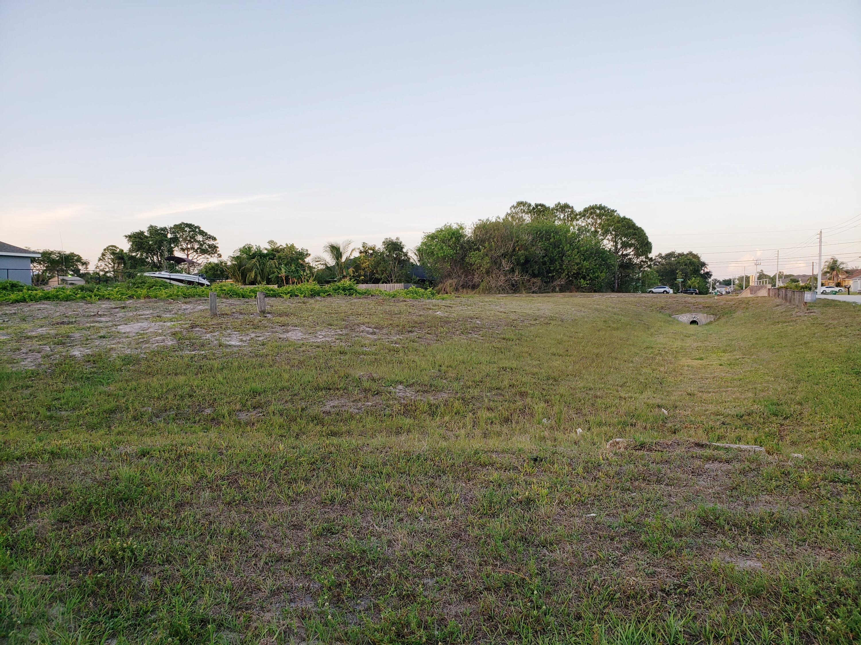 LOCATION, LOCATION, LOCATION. THIS LARGE CORNER LOT IS .32 ACRES & HAS ALREADY BEEN CLEARED FOR YOU...Think of the time saved and the extra money you get to keep in the bank. This large cleared parcel is ready for your dream home to be built! Excellent drainage. Lot sits nice and high, verify with your builder if additional fill is even needed. Location is great for the commuter, within a few miles of I-95 and the Florida Turnpike. close to medical, restaurants and shops. Many new and beautiful homes all around you.