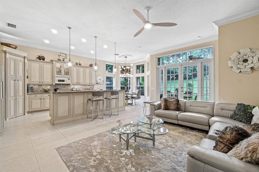 Light, bright, spacious, and highly upgraded Caribbean III single family home in beautiful Valencia Shores. This fabulous home will ''WOW' even your fussiest buyers. Beautiful 24x24 porcelain tile throughout living area, chic and impressive light fixtures throughout, updated kitchen with lots of bells and whistles, 2016 a/c, newer hot water heater, newer washer dryer, accordion shutters, crown molding, coffered and tray ceilings, and the list goes on. This home also features a lovely screened in patio with 150 ft of green space behind. Valencia Shores is an active 55+ community with a renovated clubhouse and lots of great amenities.