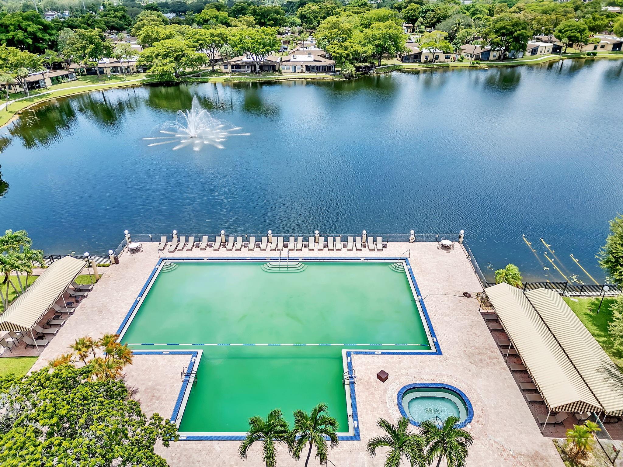 RESORT STYLE LIVING IN THIS BEAUTIFUL COMPLETELY REMODELED APARTMENT. UPGRADED KITCHEN WITH WOOD CABINENTS AND GRANITE COUNTERTOP, TILE FLOORS, BOTH BATHROOMS HAVE BEEN UPDATED. RECESSED LIGHTNING THRU OUT. AIR CONDITIONER IS LESS THAN 1 YEAR OLD, ENCLOSED PATIO, PERFECT FOR DEN/COMPUTER ROOM. THIS IS A FIRST FLOOR APARTMENT WITH PARKING RIGHT BY THE FRONT DOOR, ONLY STEPS AWAY FROM THE MILLION DOLLAR CLUBHOUSE AND RESORT STYLE POOL AND SEPARATE HOT TUB/SPA, AND A SMALLER POOL IN BACK OF APARTMENT. AMENITIES INCLUDES TENNIS/PICKLE BALL COURTS, BILLIARDS,AN EXERCISE ROOM, SAUNA, A CARD ROOM AND MANY SOCIAL EVENTS AT CLUBHOUSE. GREAT LOCATION, CLOSE TO SHOPPING AND RESTAURANTS, PUBLIX IS ACROSS THE STREET, LESS THAN 2 MILES TO HARD ROCK CASINO. SEEING IS BELIEVING, YOU WON'T BE DISAPPOINTED!