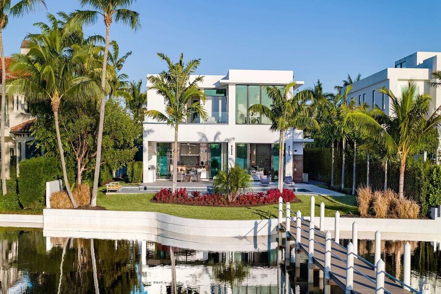 Experience refined, effortless living in this gorgeous waterfront estate in the private enclave of Hypoluxo Island. Wide Intracoastal views greet you upon entry, framed by soaring ceilings, an open-concept plan, and exquisite finishes throughout. With 5,000+ sq ft under air, this home features 5 bedrooms, 6.5 baths, a gracious living room, chefs kitchen with Wolf appliances, an oversized island opening to the dining and family rooms with a large built-in bar and separate office. The luxurious primary suite impresses with dual dressing areas, spa-level baths, & its own waterfront terrace. Outdoors, enjoy a sunset facing pool & spa, covered loggia and private dock. Complete with elevator, full-house generator, and a 3-car garage. This is a rare opportunity and a boaters dream! A short walk to the Beach, Shopping, Restaurants and the Eau Palm Beach Resort (featuring Nobu). Minutes to the center of Palm Beach, West Palm Beach & PBI Airport.