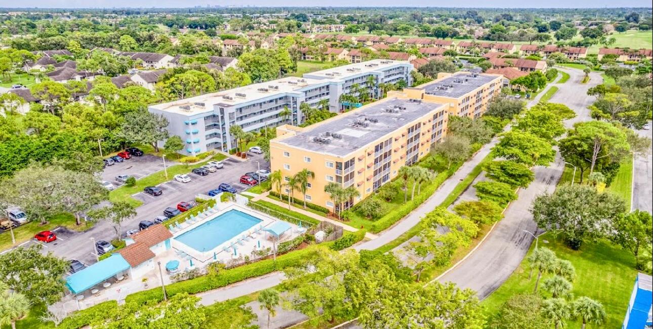 Welcome to a beautifully updated condo where peace of mind and sophisticated comfort go hand in hand. Outfitted with hurricane-impact windows and doors, newer roof, and a fire sprinkler system, this residence ensures safety and durability while exuding warm, inviting charm. The open-concept layout invites you to explore thoughtfully designed spaces made for both everyday living and entertaining.At the front of the condo, a spacious guest bedroom offers comfort, privacy, and ample closet space, while a versatile second room--currently serving as a home office and guest suite with a daybed and trundle--easily adapts to your lifestyle needs.