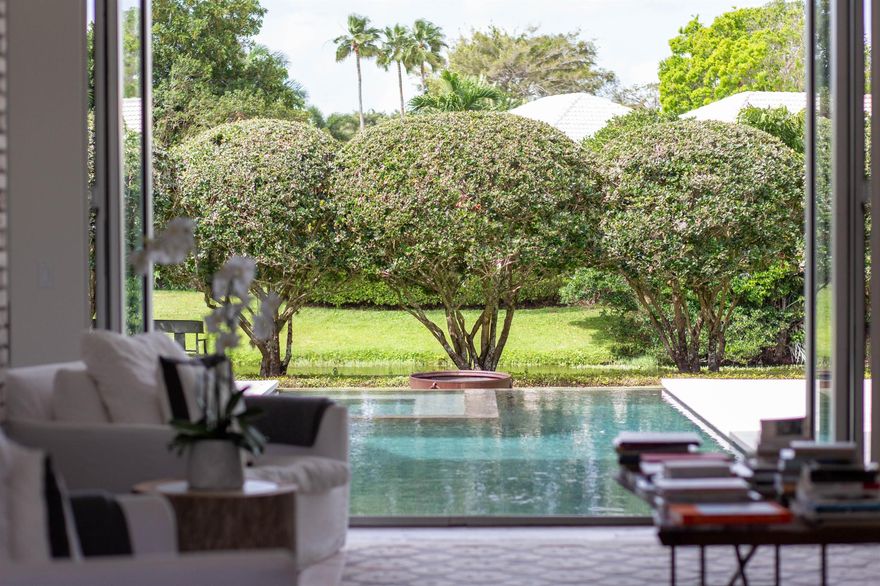 This beautiful Gem is a must see!!!Located in the prestigious Golf Brook neighborhood of Palm Beach Polo and Country Club, this Gorgeous 4 bedroom, 4 1/2 bath home has a very warm and unique style.  No detail has been spared. Features include an office, billiard room, hardwood floors throughout, 2 wood burning fireplaces, impact windows and doors, and a separate room with its own full bathroom, which you can use as an office, guest room or piano room!!!Impressive gourmet kitchen with top of line appliances including a Subzero Pro 48 refrigerator, 60 in Bluestar Heritage Range, and 2 full size Bosch dishwashers. Outdoor space includes an amazing pool and luscious landscaping.  Property has a beautiful water view.  Must See!