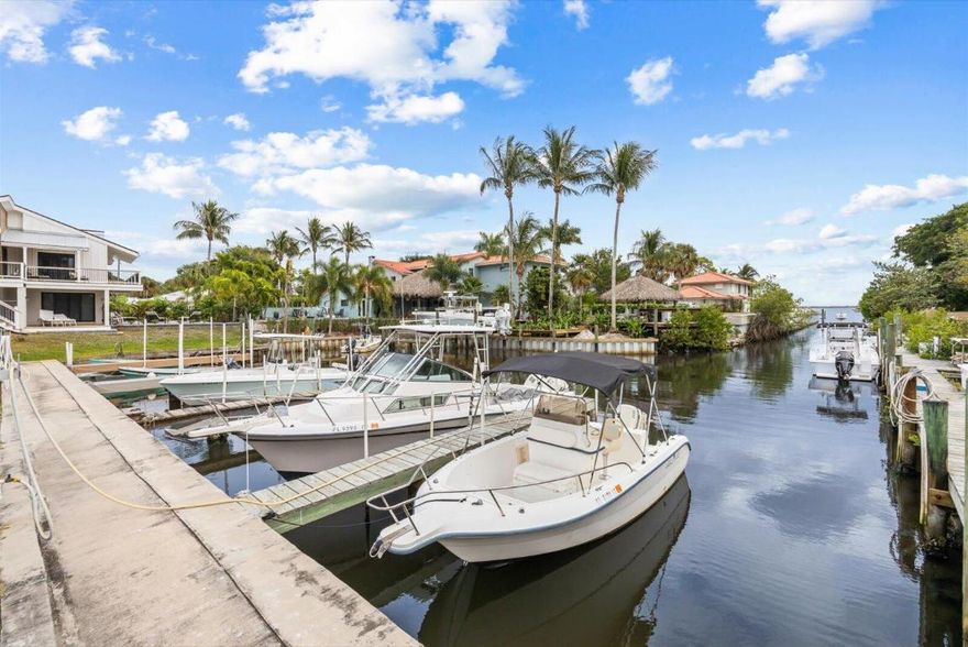 Discover a Rare Key West-style concrete block cottage in the coveted Sunset Estates waterfront community. Perfectly positioned directly across from the marina, this charming home offers effortless access to both the river and inlet—an ideal retreat for boaters and those seeking a true Florida lifestyle. Pride of ownership shines throughout, featuring a newer kitchen and updated master bath, tankless instant hot water heater, and updated electrical (2013). The seller leases a 25-ft dock for only $1,000 per year, delivering exceptional value rarely found in waterfront communities. A standout bonus: rare extra parking accommodates up to a 45-ft RV, plus an 11' x 20' custom workshop/shed. Sewer is available with assessment paid—just needs connection.