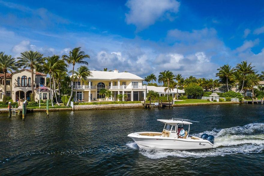 Custom built by Mark Timothy, known for his attention to detail and the ultimate in craftsmanship, this elegant deep-water gated estate is sited on an oversized lot and located only a few blocks from famed Atlantic Avenue of Delray Beach. The home's rare location, on one of the widest yacht basins on the Intracoastal Waterway, is surrounded by beauty and serenity.
Meticulously finished this 4/BB, 5.1BA residence offers a spectacular two-story entry with large windows bathing the interiors in natural light.  The spacious first floor master suite overlooking a resort like pool and the intracoastal features floor to ceiling windows and a spa like master bath that create a private Zen like retreat. The first-floor design with a feeling of openness was created to provide extensive water views perfect for a carefree Florida lifestyle. The gourmet kitchen with a center island, loads of storage and custom appliances make entertaining a delight. Three beautifully appointed bedrooms all with private baths and built-in closets complete the second floor. A private office with finely crafted built-ins, waterside family room with wet bar, formal and informal dining all opening to a waterfront loggia complete with outdoor kitchen and fireplace.  A full house generator, three car garage, private deep water dock fit for a yachtsman, all combine to add to the allure of the estate and make it one of the most compelling offerings in Delray Beach.