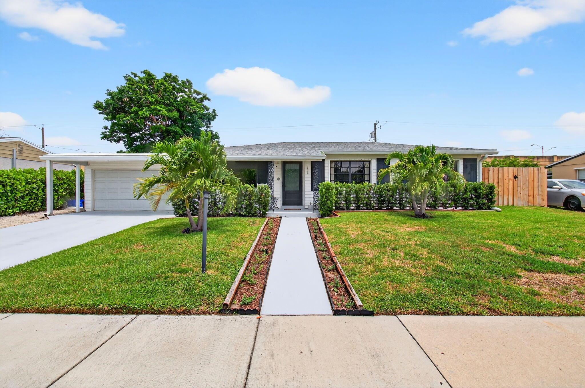 Move right into this beautifully updated home in Lake Osborne! This turnkey 4Bed/2Bath/2Car Garage home offers over 1700sqft of open-concept living space with a split-bedroom floor plan, luxury tile flooring throughout and 2024 ROOF. Enjoy the Florida lifestyle with NO HOA while living only 10 minutes from the Beach. The eat-in Kitchen features white quartz countertops and decorative tile backsplash, 42'' white cabinetry, stainless steel appliances, breakfast nook and large center island with plenty of extra storage and seating. The Primary Suite showcases a spacious ensuite with double sink vanity, soaker tub and separate shower, walk-in closet and Impact Glass sliders leading to the backyard while the three sizable guest bedrooms share an updated full bath. Additional features include: