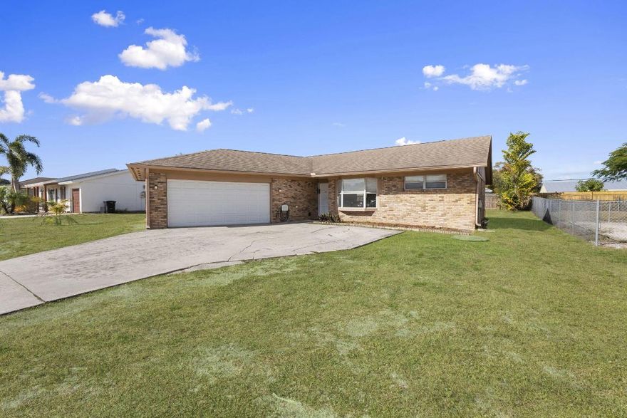 Don't miss this opportunity to own a 3-bedroom, 2-bath, 2-car garage brick home located in Port St. Lucie. This home sits on a spacious .23-acre lot, offering plenty of room for outdoor living. Inside, you'll find LVP flooring throughout the main living areas with tile in the bedrooms and bathrooms. The kitchen features newer stainless steel appliances, and major systems have already been updated, including a 2017 roof, 2025 A/C, and 2020 hot water heater. With these improvements already in place, this home provides comfort and peace of mind at an exceptional value. Priced under $400,000, this is a great opportunity you won't want to miss.