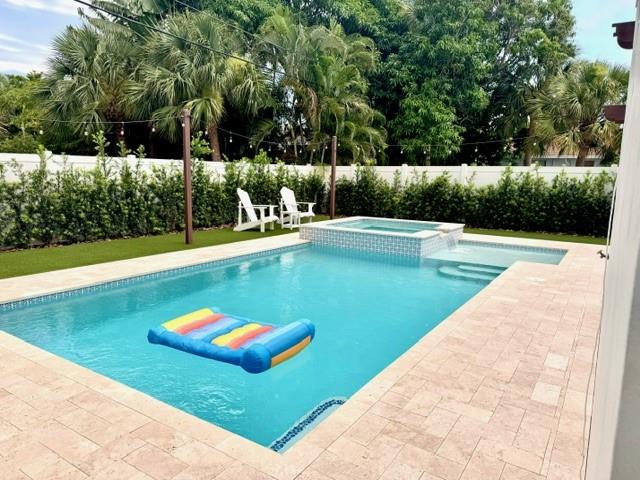 Welcome to Paradise! This turnkey 3 bed/2 bath beach retreat is a perfect home or vacation property that sits just .9 miles from the beach and is walking distance to vibrant Atlantic Ave and Pineapple Grove offering a number of restaurants, boutiques, art galleries and coffee shops. The home has CBS construction and a newer roof (2019) with impact windows/ doors throughout. The backyard will be your own private oasis with a huge pergola and brand new salt water pool and hot tub with a waterfall that spills over into the sun shelf. The front and back yard are also both fully fenced with new tropical landscaping with artificial turf in the backyard. This charming home and beautiful city truly feels like vacation everyday!