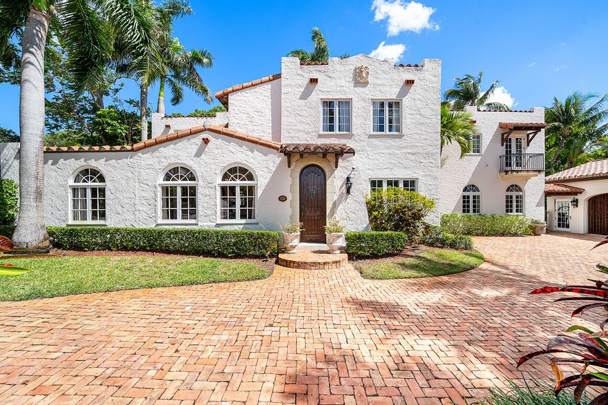 This iconic 1920's Mediterranean Revival Home blends historic charm with contemporary updates in the heart of El Cid, one home off of S. Flagler Drive and the Intracoastal.  Distinctive features include mahogany and pecky cypress doors, custom wall niches and refined architectural elements that elevate the home's timeless appeal. The estate sits on an expansive lot created through the acquisition of the neighboring property. An approx. 720 sqft airconditioned garage was built complimenting the historic main home as a non-contributing structure.