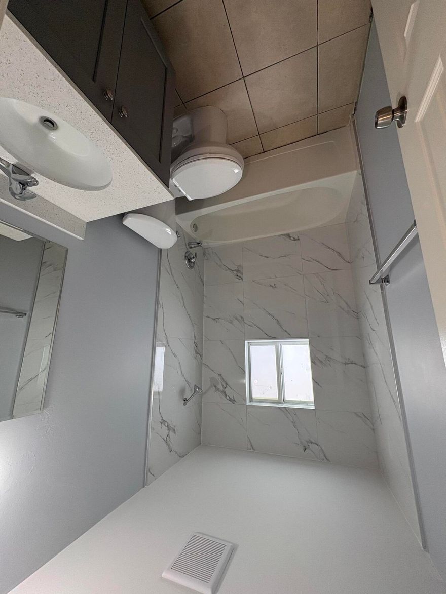 All New Renovated 3 bedroom unit, offers modern comfort and style throughout. The Band-new kitchen features sleek quartz countertops, complemented by all new Stainless-steel appliances, creating a clean and contemporary space perfect for cooking and entertaining. This home has a great outdoor space right off the kitchen, making it great for entertaining. The unit has tile flooring throughout for low maintenance. Freshly painted enhances the bright and inviting atmosphere. Then for added convenience, the unit also includes a new state of the art washer and dryer combo making everyday living easy and efficient. The outdoor space is also fenced in for added security for children to run and play.  Don't wait this unit will not last long.  Call for your private showing today