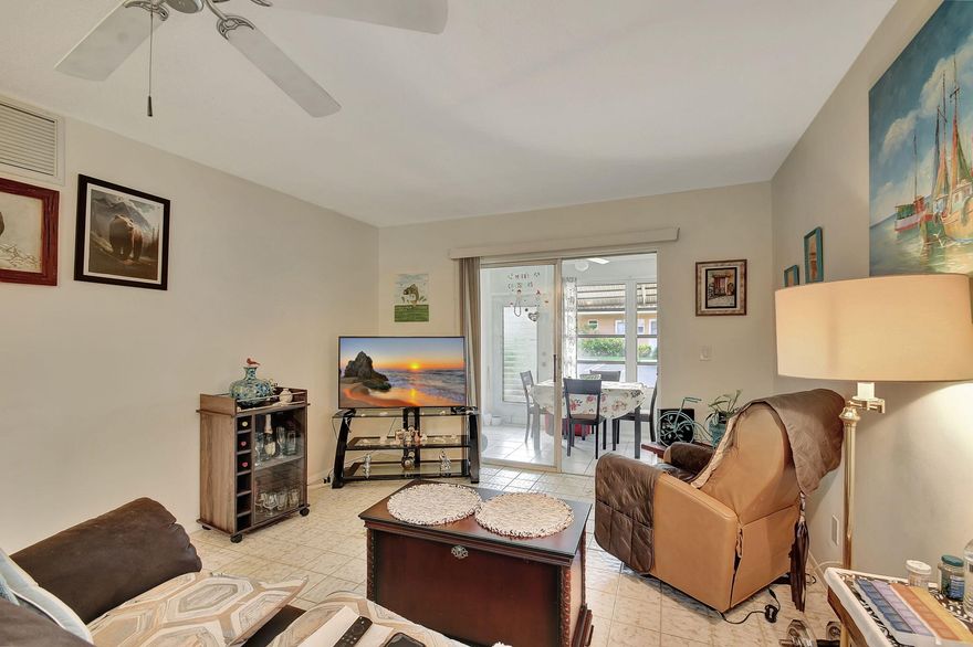 Live your best Florida life in this meticulously maintained ground-floor condo in the vibrant 55+ Village Royale Greendale community, which combines comfort and modern style. The residence is fully move-in ready and has updated engineered flooring in the bedrooms, newer appliances, and a newer air-conditioning system. The kitchen sparkles with Frigidaire appliances, granite countertops, and an eye-catching hexagonal tile backsplash. Crown molding adds architectural elegance. It is spacious, thoughtfully designed, and offers a clean, welcoming ambiance in every room. Residents enjoy a lively social scene with access to a clubhouse, pool, and shuffleboard courts. Ideally located close to shopping, dining, and a short distance to stunning beaches, a low-maintenance lifestyle.