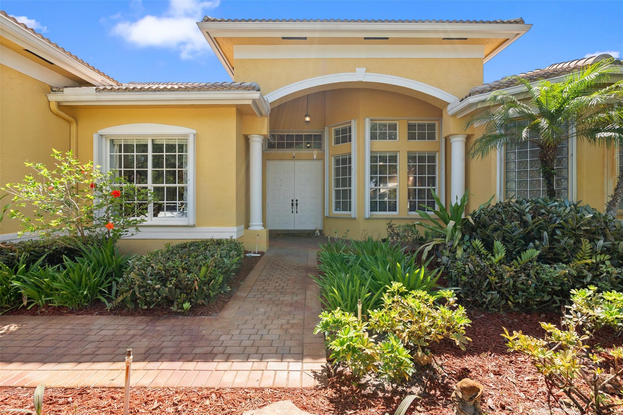 This stunning 5-bed/4 bath 1 story, on a builder’s acre of land. Features accordion shutters, underground sprinklers with rain shut off, fed by canal water lush landscaping an expanded pool deck, with an 18x30 free form in ground salt pool. Glass block Master Bath privacy windows. Features an expanded entry foyer with coffered ceilings in throughout the home. Marble tile in the master bath, a cabana bath A formal living room/dinning room w/ ceramic tile in common areas. Cased windows, base boards, and crown molding in most. Elongated toilets w/ quiet flush. Water treatment system. A gourmet kitchen, granite counter tops, tremendous island a vented outside hood system. A New Refrigerator, dishwasher, cook top, washer Dryer. 5/30/25 new HVAC with VU treated air. New wood blinds 7/13/25.