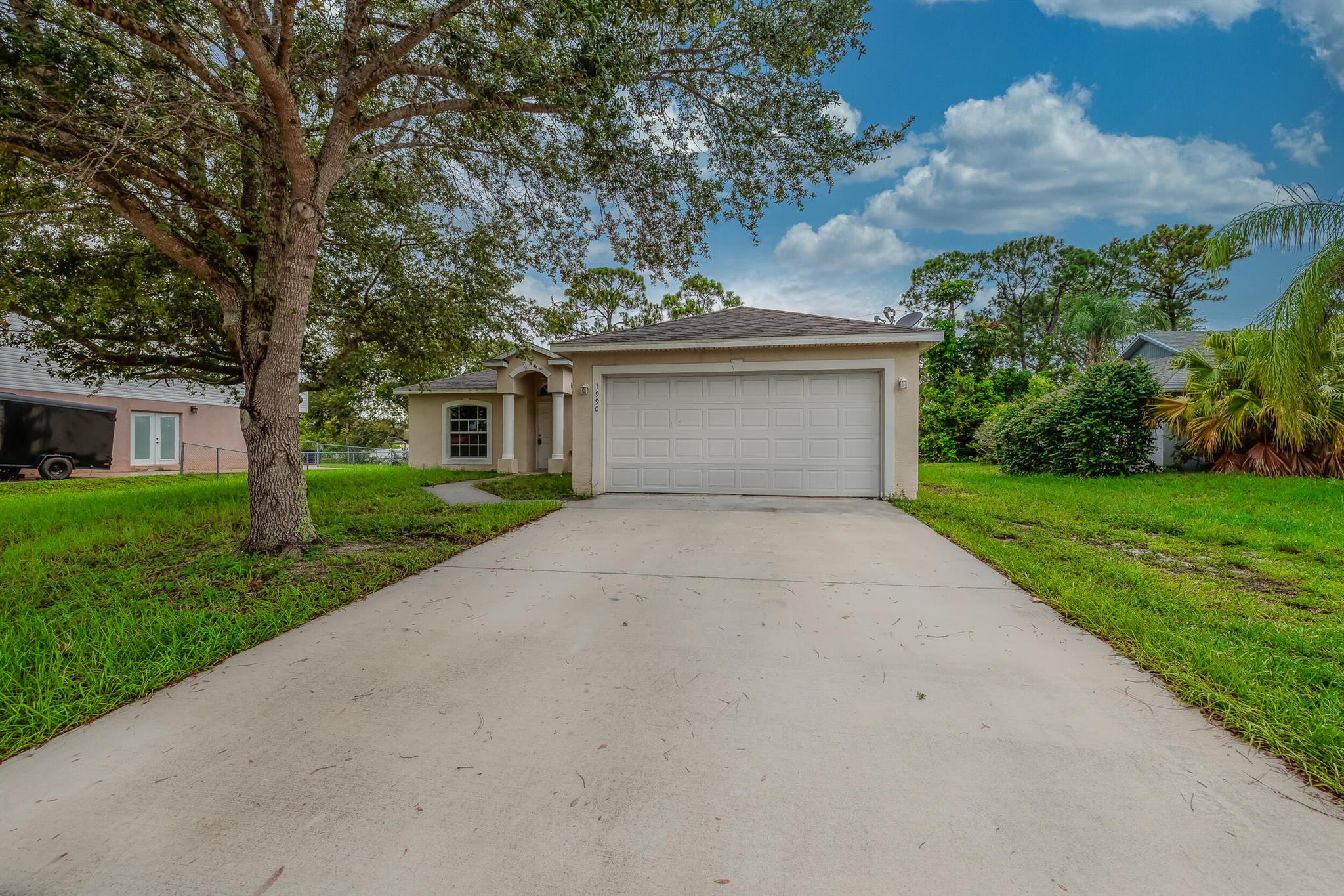 Opportunity awaits with this 3-bedroom, 2-bath, 2-car garage home located in Port St. Lucie. This property offers a spacious layout filled with natural light and sits on a generous lot with a large backyard, ideal for future outdoor living spaces or a pool. This home provides the perfect blank canvas for investors or buyers with a vision. With solid bones, a great location, and plenty of square footage, there's endless potential to transform this space into something special.Whether you're looking to renovate and resell or create your dream home from the ground up, this is a rare opportunity in a sought-after neighborhood close to schools, shopping, dining, and major highways.