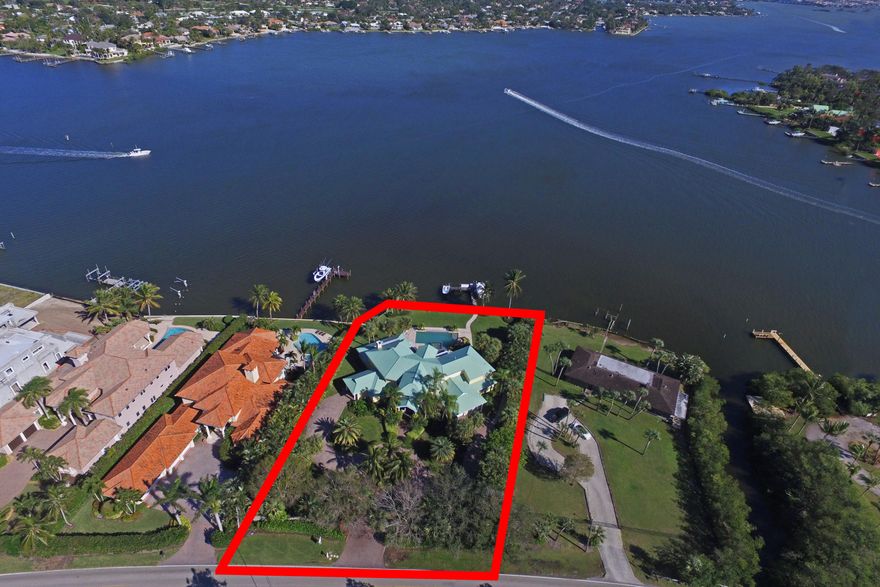 One of the premier locations on the northwest fork of the Loxahatchee River! Custom Key West-style home on nearly an acre of land with gated entry and approximately 155 feet of deep water frontage. The spacious rear yard offers a new salt water, heated, infinity pool with 10 ft. spa, sun shelf & large cap rock waterfall, in addition to an oversized dock with 2 lifts. A-rated schools and just minutes to the ocean and championship golf courses. This riverfront estate combines the best of what Jupiter has to offer!
