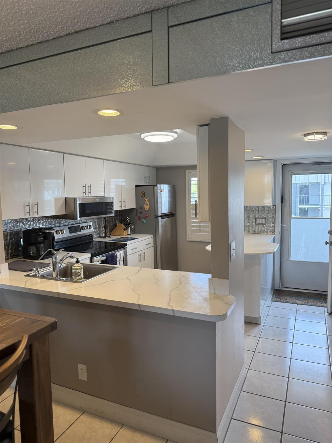Updated 2 BR, 2 BA condo on the water in gated community - The Island Club. On top level of 4 level bldg w great views of canal. It boasts screened balc w hurricane shutters, walk-in MBR closet, kitchen island, plantation shutters, 1 assigned parking spot+guest parking, and more! Amenities include 2 pools, fitness center, billiards room, rec center, tropical garden, guard house, laundry facilities, elevators. Close to markets, shopping, & restaurants, less than 2 miles from beach. All furnishings nego. BONUS: Community just undergone required 50-year inspection. All units were assessed over $25,000 to make many improvements such as new water & sewer systems, new roofs, repair and paint the ext of all buildings, rebuild balconies, new parking lot, along with many other items.