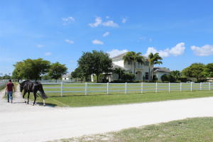 Lovely Saddle Trail home and barn. Built with the finest upgrades this 5 bedroom 5 bath estate home and 4 stall center isle barn are a perfect fit. Situated on just over 2 acres and within hacking distance to horse show and easy access to Bridle Path. Four 12 x 14 stalls with room for more with grooms quarters.