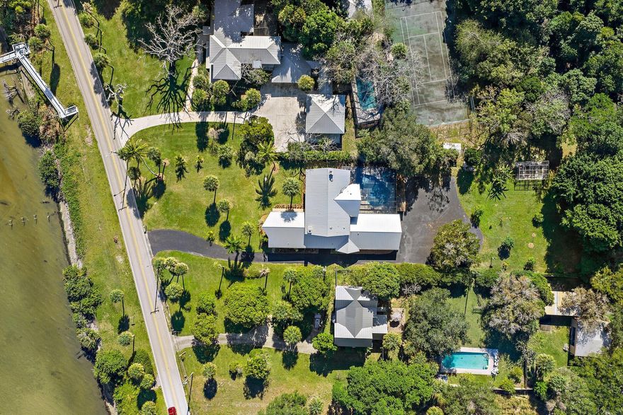 Discover the serenity of waterfront living in this private residential retreat, where breathtaking views of the scenic Indian River are enjoyed from nearly every room. Seamlessly blending timeless beauty with contemporary sophistication, the home underwent an extensive renovation from 2021-23, featuring a gourmet kitchen, spa-inspired bathrooms, full impact windows, a seamless metal roof, 2 wood burning fireplaces including one in the primary suite, a whole house generator, and updated septic system. Thoughtful details enhance everyday living, with custom built-in shelving in every bedroom closet to maximize space and minimize clutter. The open-concept kitchen and living areas create an entertainer's dream, ideal for gathering with family and friends in a light-filled setting. Step outsi