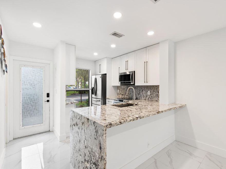 Discover the glamour of Contemporary Townhomes nestled in the Pines West Gated Community, just minutes away from the vibrant nightlife of Wilton Manors and the pristine beaches of Fort Lauderdale. This meticulously remodeled residence boasts upgraded appliances, exquisite marbled tile flooring, and sleek granite countertops. Step outside onto the spacious patio, an oasis seamlessly extending from the living room, inviting you to bask in the open air or host unforgettable gatherings. Upstairs, two generously sized bedrooms await with attached baths for convenience, and a dedicated laundry area adds a practical touch. This is not just a home; it's a vivid illustration of contemporary living. Square Footage from IMAPP