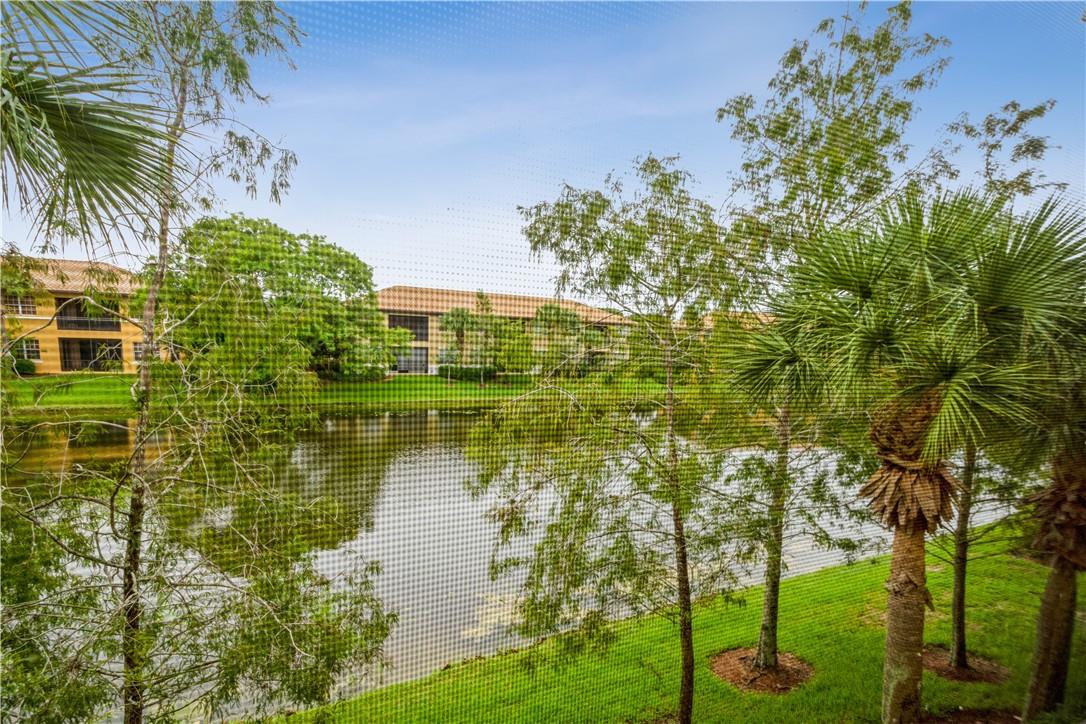 Immaculate & Move-In Ready! Welcome to this beautifully updated 3-bedroom, 2-bath coach home with a private garage, ideally located on the preferred second floor in the sought-after Heron Bay community. Enjoy soaring ceilings and a welcoming foyer that set the tone for this spacious, light-filled residence. Take in breathtaking lake and sunset views from your expansive screened patio—perfect for relaxing evenings and entertaining guests. The triple-split floor plan offers privacy and functionality, with neutral tile throughout the living areas and warm laminate flooring in the bedrooms. Bring your fur babies!