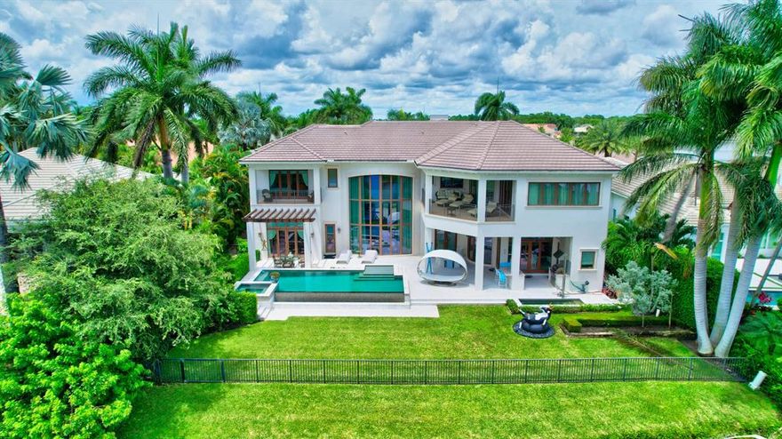 Custom smart home with 5 bedrooms, office, home theater, and one of the best lake & golf course views in St. Andrews CC! Built in 2012 with all impact windows, elevator, full-house generator, & more. The interior is open & bright, with custom designer details throughout. Gourmet chef's kitchen with double-wide Wolf gas cooktop & double ovens, 2 Sub-Zero refrigerators, 2 sinks, and large butler's pantry. Upstairs is an ultra-spacious master suite, with his & her baths, room-size custom closets, and a covered balcony. The 2nd floor also has 3 ensuite guest bedrooms and a game room. Outside is a resort-style pool w/spa, open and covered patio areas, and summer kitchen with built-in BBQ. Southern exposure and lake & golf course views. Note: Some furniture has been virtually restaged.