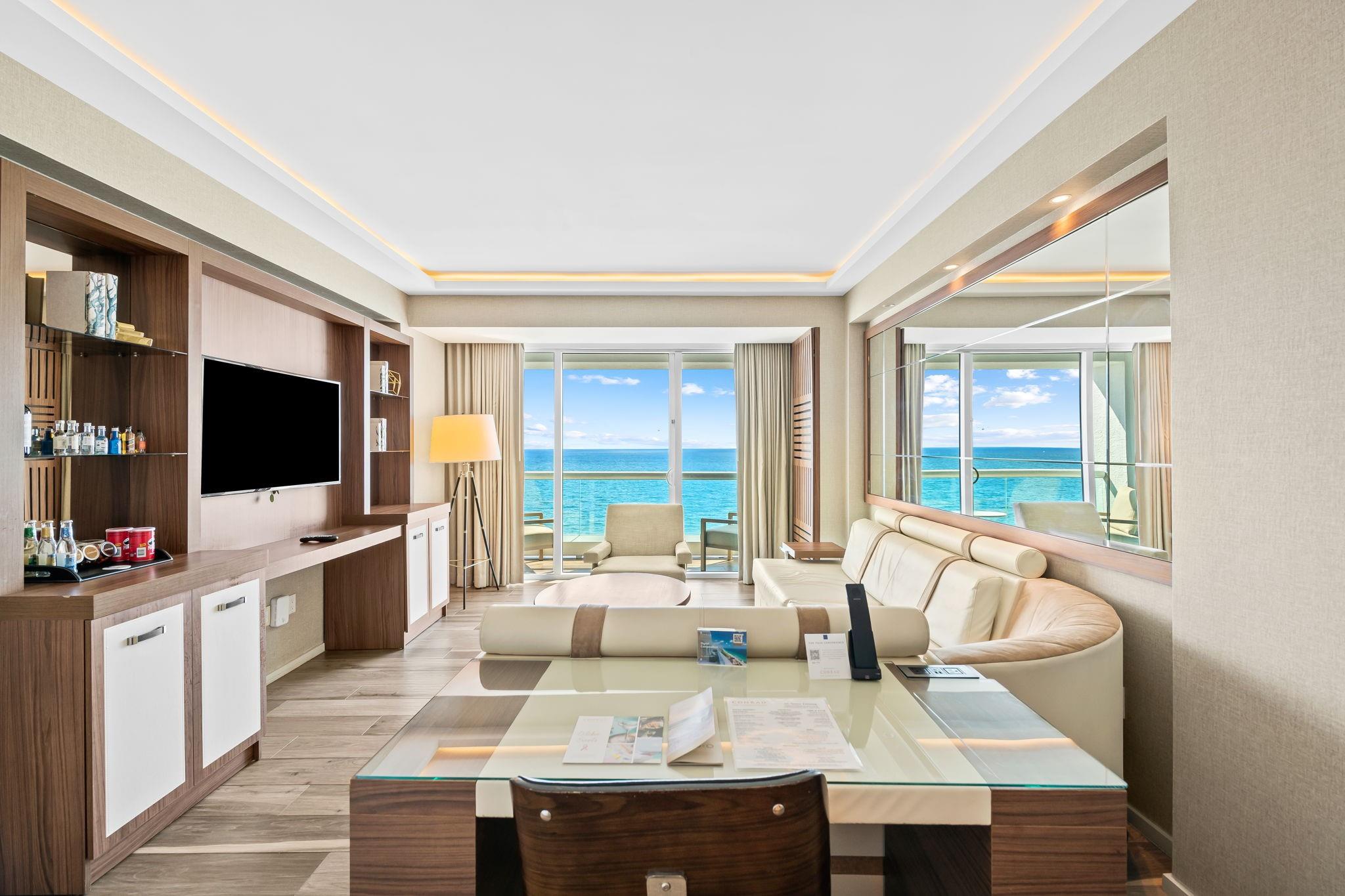 Indulge in the epitome of beachfront living in this luxurious 1-bedroom, 1/2-bathroom residence. Perfectly situated
adjacent to the Four Seasons, this Conrad-managed property offers unparalleled ocean views and direct beach
access. Immerse yourself in a world of elegance with a fully furnished interior designed by Arte Facto, complete with marble bathrooms and a gourmet kitchen featuring Sub-Zero and Wolf appliances. Enjoy the ultimate in convenience with 24-hour valet, daily housekeeping, and laundry services. As a resident, you'll have exclusive access to the hotel's world-class amenities, including a state-of-the-art gym, rejuvenating spa, and inviting pool. This pet-friendly oasis presents the flexibility of daily rentals through the hotel program or self-management.