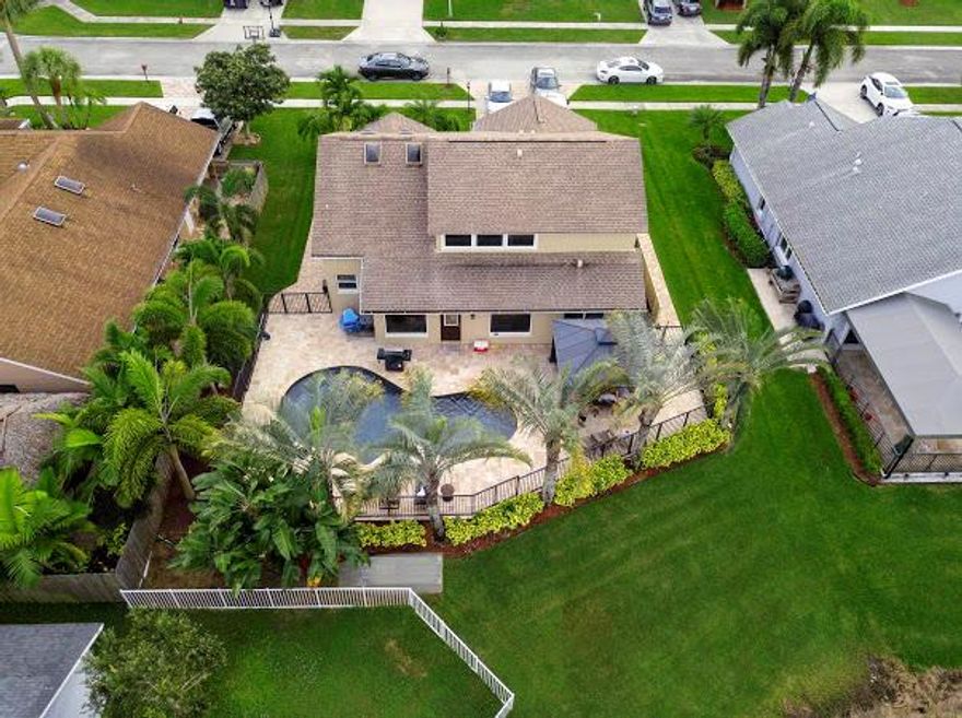 Stunningly remodeled from top to bottom, and immaculately presented, This hidden gem Features Hurricane windows throught. This home has been lavishly completed, and is bathed in natural light. The high ceilings create a timeless style and the generously proportioned interior flows effortlessly from the open space living areas to a main floor master bedroom. Boasting a gourmet kitchen, solid wood cabinetry and custom granite, freshly painted, 24x24Italian tile, hardwood, electronic bar, 6'' baseboards, bdrm 4 converted to loft with huge closet. Beyond the glass is your outdoor oasis impeccably finished, fully fenced with a natural cold stone scaped free form salt pool, calming waterfall, and stunning ambient lighting enveloping you in lush palm trees while you gaze at the stunning water vie