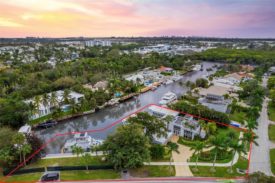 Boasting over 200' of combined deep water frontage double lot estate this game-changing luxe over-water retreat with crazy great multi-slip deep-water dockage. Main home and adjacent property comprise this estate. Water-frontage maximized to the fullest w/out blocking the view. 90’ yacht dockage w/hip-tie TENDER + 5 other docks. A distinctive, Frank Lloyd styled masterpiece. Step in the door and you are on board. Only two such properties ever built in FTL. The artisan-owners have improved and impeccably maintained every inch. Expected, well-appointed luxurious accoutrements abound. The multi-dimensional pool, cabana, and light-infused expanses propel this estate and dockage heaven to game-changing status. If ever there was a must-see, this is it.