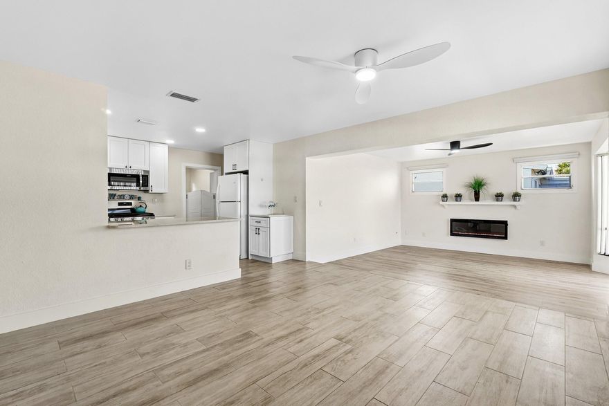 Welcome home to this beautifully refreshed 3-bedroom, 2-bath home that delivers genuine move-in ready living across 1,216 square feet of thoughtfully updated space. This new listing combines smart upgrades with a practical split-bedroom layout designed to make daily life feel effortless.  Inside, natural light pours through the freshly painted interior, enhanced by custom high-hat lighting and new ceiling fans. Durable wood-plank porcelain tile flows throughout, creating a clean and cohesive look from room to room. The fully remodeled open kitchen stands as the centerpiece, boasting quartz countertops, custom cabinetry, generous storage, and brand-new stove and dishwasher — because cooking at home should always feel inspiring, never inconvenient.The primary bedroom benefits from the   privacy of the split floor plan, while the fully remodeled primary bath features a walk-in shower with floor-to-ceiling tile. A fully updated guest bath keeps visitors comfortable, and indoor laundry adds everyday convenience that quickly becomes indispensable.  Step outside to an oversized screened back patio measuring eighteen by eight feet, overlooking a beautifully landscaped and fully fenced backyard — perfect for pets, children, or cultivating your own personal garden retreat. Major updates including a new roof and new air conditioning system provide lasting peace of mind, while natural gas service adds welcome efficiency.  Situated near popular dining, shopping, entertainment, beautiful beaches, and convenient access to major roadways, this home checks every box. Schedule your private tour today and discover just how satisfying a truly move-in ready home can feel.