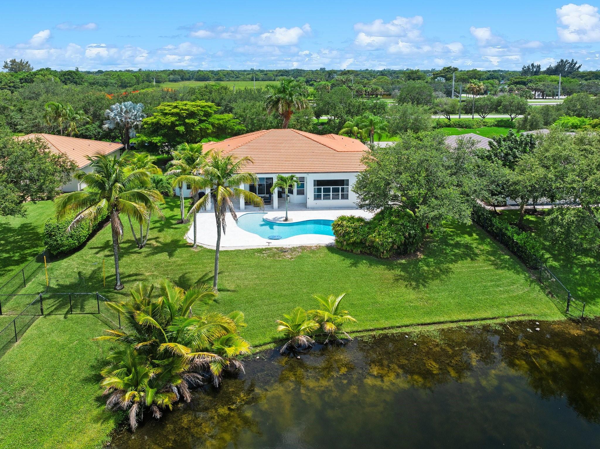 LIVE LUXURIOUSLY IN THIS PROFESSIONALLY DESIGNED 6BR/4BA HOME IN A SECURE GATED COMMUNITY. THE BRIGHT, OPEN FLOOR PLAN BOASTS SKY-HIGH CEILINGS AND STRIKING ITALIAN PORCELAIN TILE THROUGHOUT. THE STATE-OF-THE-ART KITCHEN FEATURES CUSTOM CABINETS, TOP-OF-THE-LINE APPLIANCES, AND A SPACIOUS PANTRY. THE ELEGANT PRIMARY SUITE INCLUDES HARDWOOD FLOORING, DUAL CUSTOM CLOSETS, AND A LAVISH SPA BATH. ENTERTAIN EFFORTLESSLY OUTDOORS WITH A SALTWATER POOL, MARBLE DECK, AND SCENIC LAKE VIEWS. A RARE, TURNKEY GEM—THIS EXCEPTIONAL HOME IS READY TO MOVE IN.