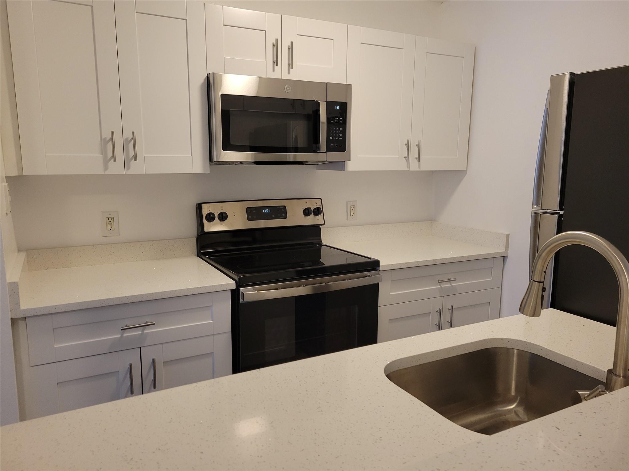 Upgraded 2/1 baths in gated community. This first floor unit is light and bright. Open floor plan with a modern kitchen. Quartz counter top, white cabinets with stainless steel appliances. New washer and dryer in the unit. Steps away from the community pool, fitness center, jogging path and tennis court. Close to beach, shopping and highway. Investor friendly