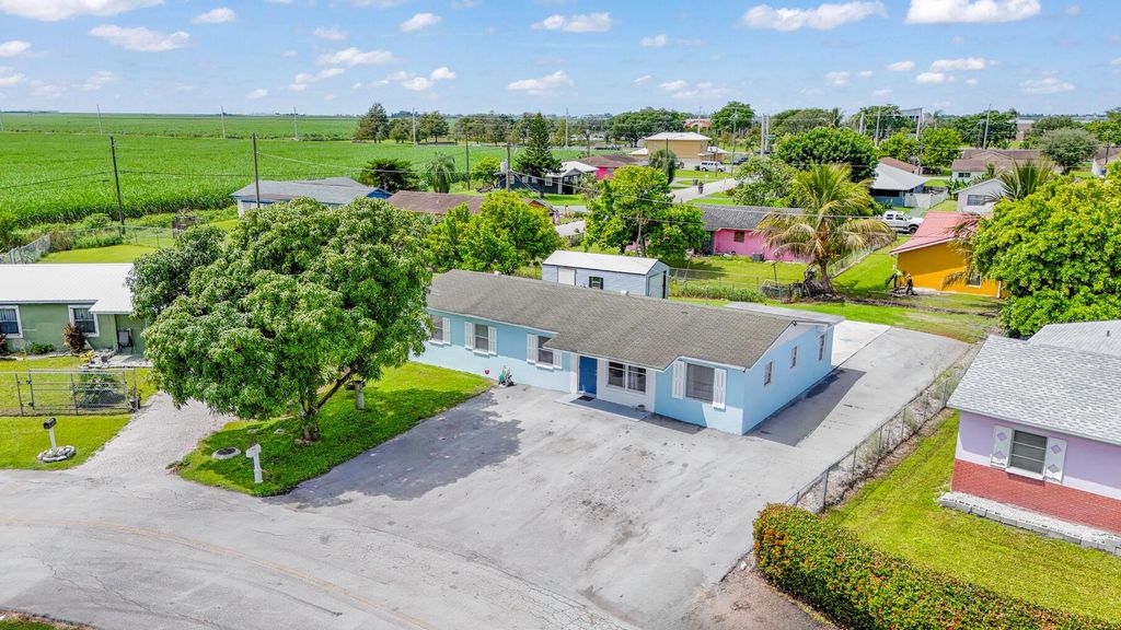 Photo of 1233 Vaughn Circle, Belle Glade, FL 33430 (MLS # R11022355)