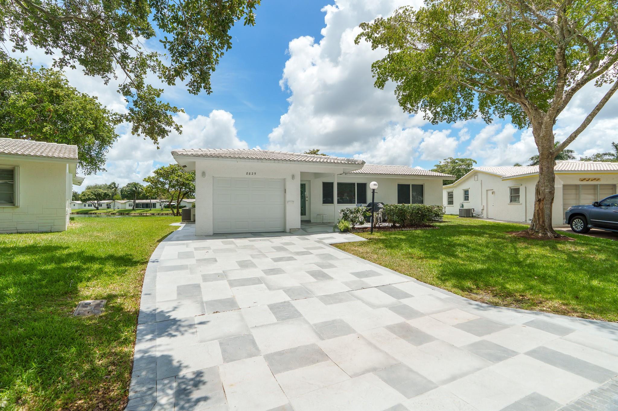 Lauderdale West, 55+ Community, 2/2 W/Garage, EXTENDED, OVER-SIZED WATERFRONT home. Exceptional home w/no expense spared to remodel. All work done by licensed GC with permits. Full IMPACT protection, porcelain wood-look tile thru-out, gorgeous kitchen w/top of the line appliances incl W/D, new AC & ducts, roll-in over sized shower, EXTRA CLOSET space, double wide driveway, too much to list, this is a like new home including the roof! No disappointments! Low maintenance includes Cable TV & Wi-Fi, repair/replace tile roof, 2 heated pools, 2 spas, saunas, 3 Tennis courts, fully equipped fitness center, billiards, ping pong, private library, professional shows, clubs, community bus at your doorstep to shopping and more. Near to shopping, restaurants etc. A must see!