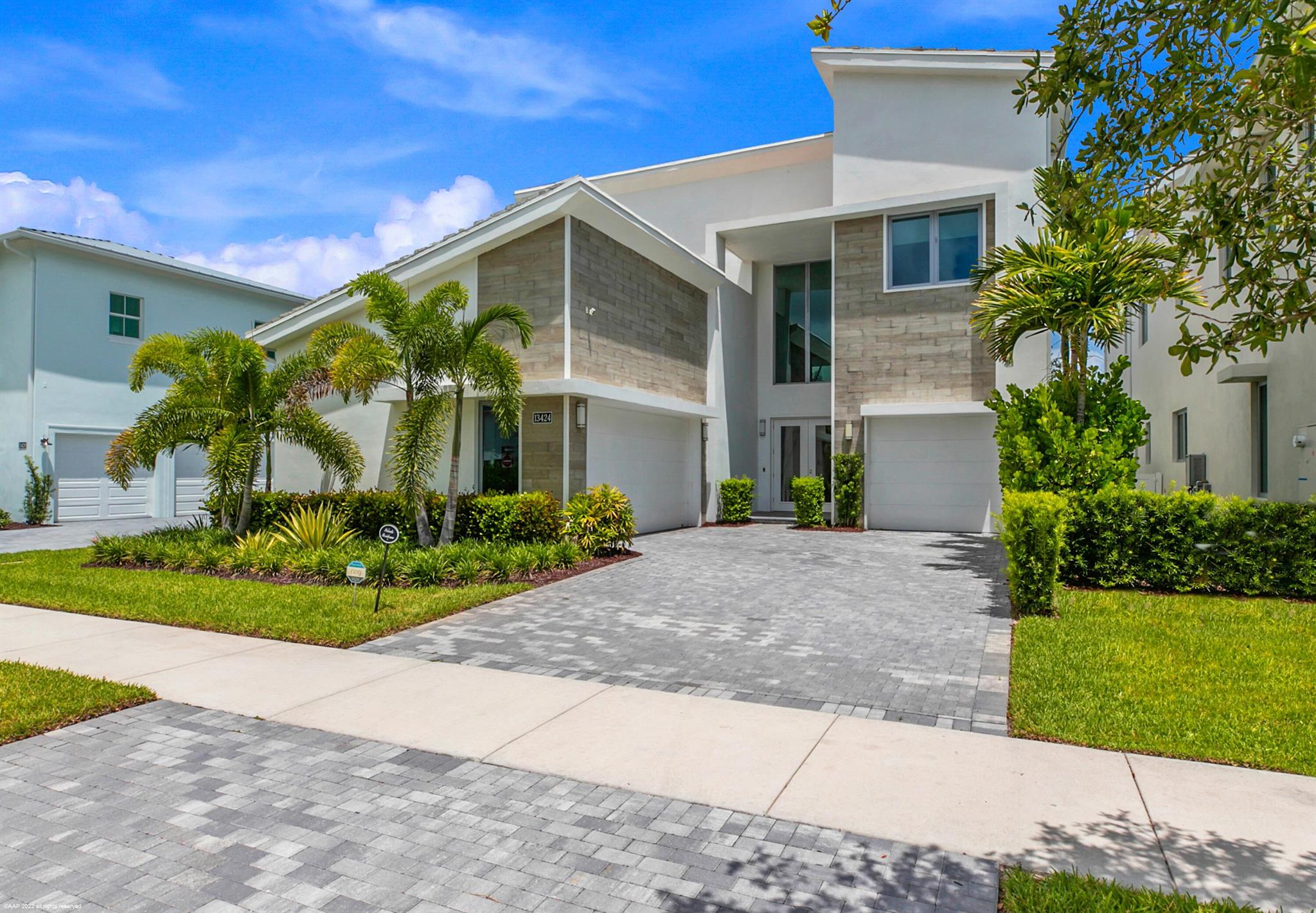 Welcome to the crown jewel of Alton--an architectural gem that redefines luxury living in Palm Beach Gardens. Just steps from the recreational hub of the community, this fully customized York model spans over 5,000 sq ft of refined interiors and sits on one of the community's most coveted lots, offering partial lake views, unmatched privacy, and resort-style amenities.Step inside to discover a chef's dream kitchen featuring dual refrigerators, wine fridges, and custom cabinetry, all anchored by a dramatic quartz island. The expansive open-concept layout flows seamlessly into a designer-appointed living space with smart home automation, electric window coverings, and floor-to-ceiling glass that opens to your private outdoor oasis.The primary suite is a sanctuary of