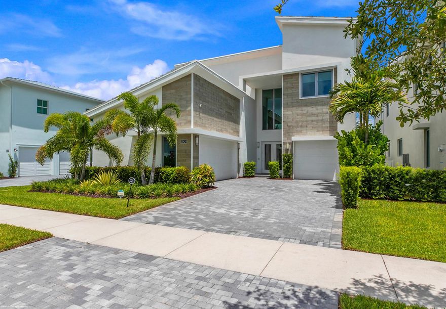 Welcome to the crown jewel of Alton--an architectural gem that redefines luxury living in Palm Beach Gardens. Just steps from the recreational hub of the community, this fully customized York model spans over 5,000 sq ft of refined interiors and sits on one of the community's most coveted lots, offering partial lake views, unmatched privacy, and resort-style amenities.Step inside to discover a chef's dream kitchen featuring dual refrigerators, wine fridges, and custom cabinetry, all anchored by a dramatic quartz island. The expansive open-concept layout flows seamlessly into a designer-appointed living space with smart home automation, electric window coverings, and floor-to-ceiling glass that opens to your private outdoor oasis.The primary suite is a sanctuary of