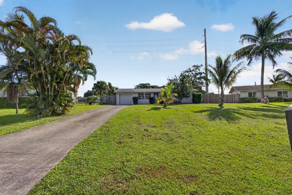 Photo of 446 E SHADYSIDE Circle, West Palm Beach, FL 33415 (MLS # B26088922)