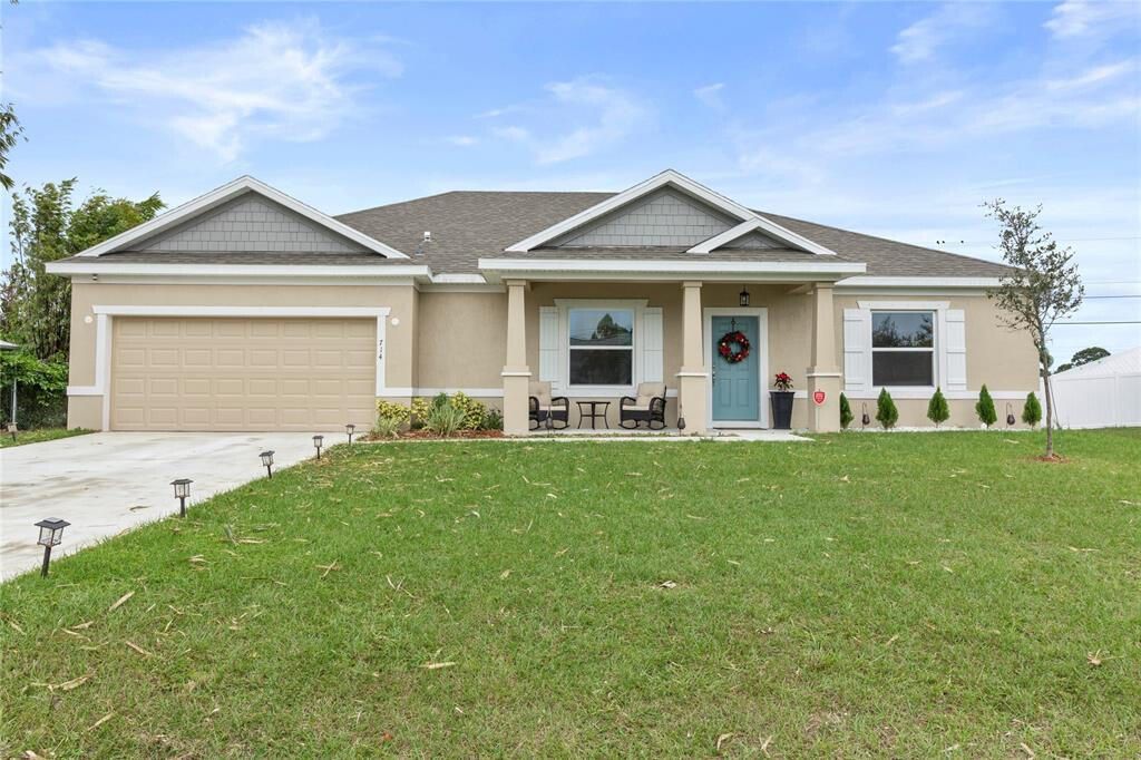 Photo of 714 SW Tupper Lane, Port Saint Lucie, FL 34953 (MLS # R10961356)