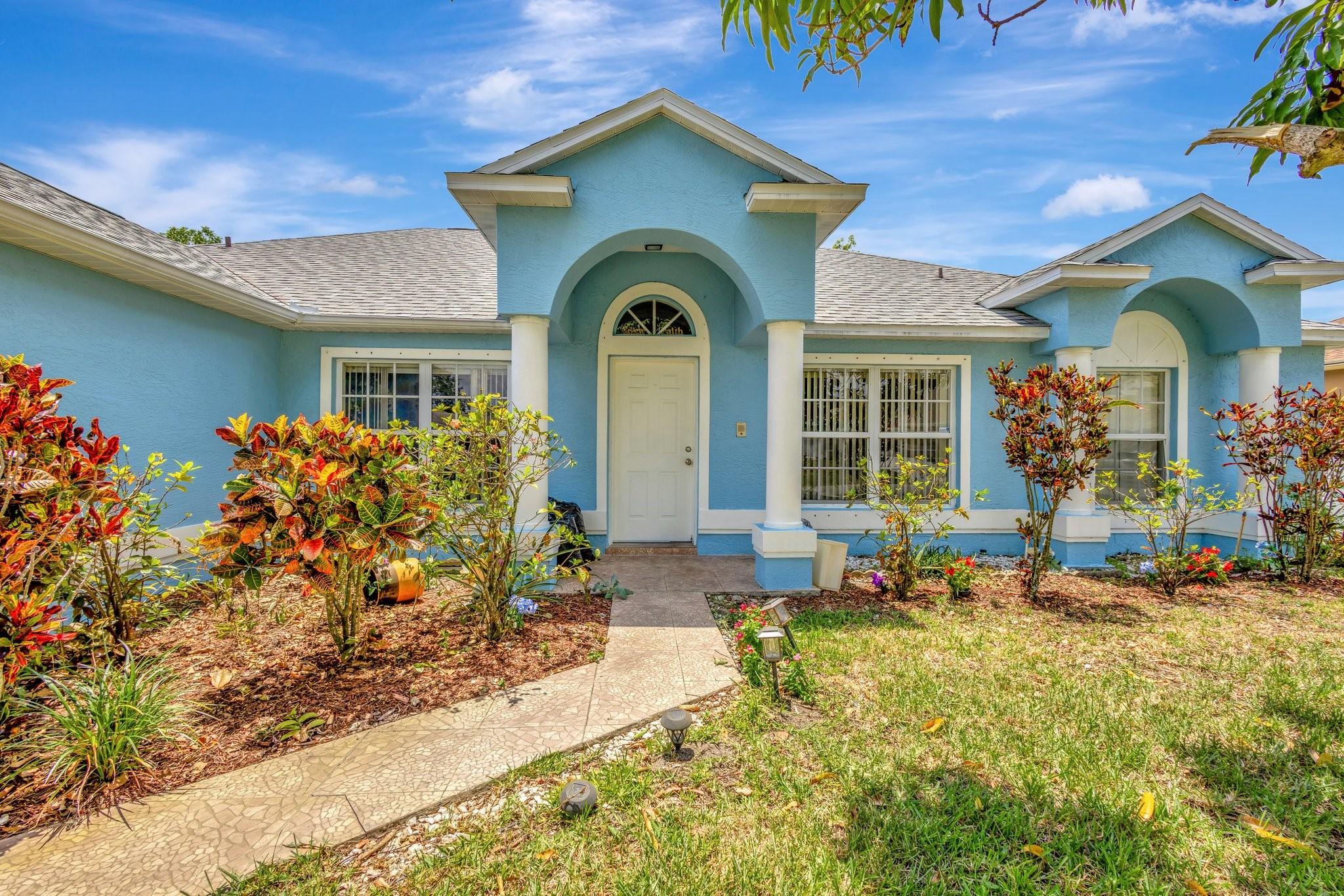 Welcome to this charming 3-bedroom, 2-bathroom home nestled on a serene quarter-acre lot adorned with lush fruit trees. Step inside to a bright, airy interior featuring beautiful tile flooring and a spacious living room perfect for relaxing or entertaining. Enjoy peace of mind with recent updates including a new roof, AC, and water heater—all replaced in 2021. This inviting home offers the perfect blend of comfort, privacy, and convenience in one of Port St. Lucie’s most desirable neighborhoods.
