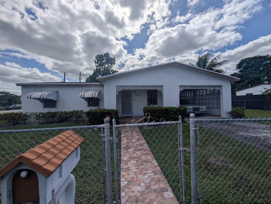 Spacious move-in ready home on large corner lot in the heart of Miami Gardens.  Newer kitchen with wood cabinets, granite countertops, and built-in breakfast/snack bar area.  Newer stainless steel appliances including refrigerator, gas stove and microwave.  Family room and large dining room perfect for those holiday family/friends gatherings.  Updated bathroom with newer tile and vanity.  Separate laundry room with new gas water heater.  Completely fenced quarter-acre corner lot with covered carport.  Backyard has room for a pool and a convenient storage shed.  Please note, the 3rd bedroom has been converted into general living space but can easily be restored.  Home needs a few updates but is absolutely move-in condition.