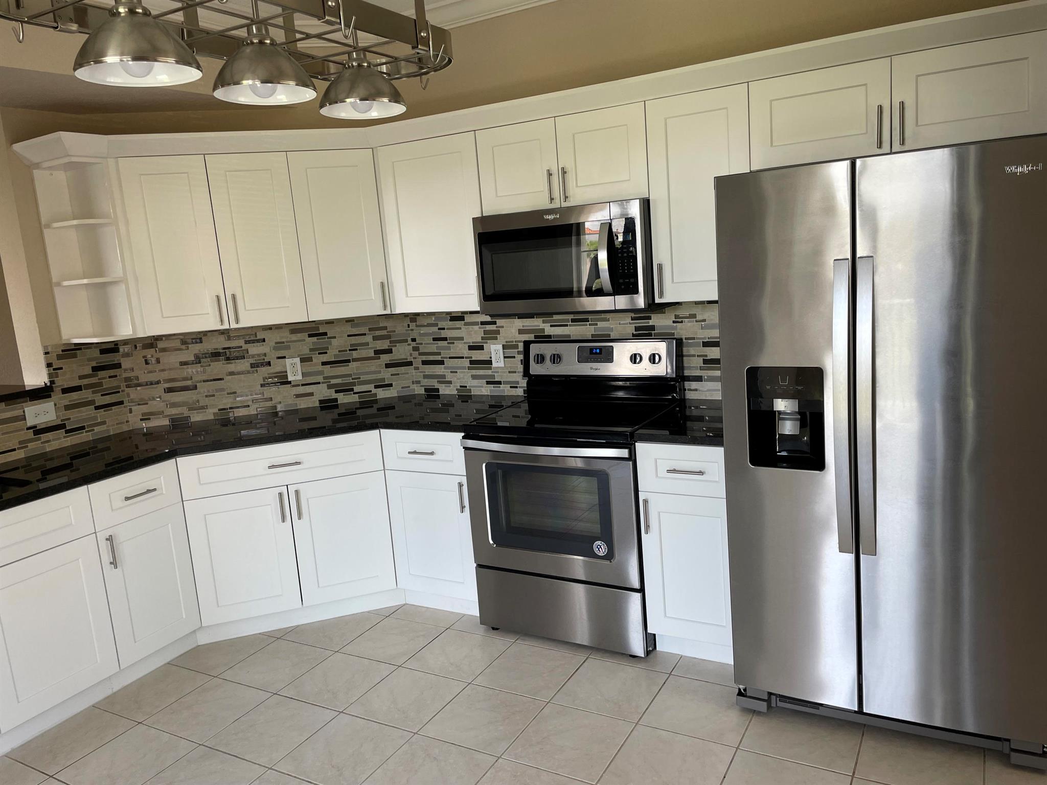 2/2 luxury condo, remodeled, modern condo in Legacy Place. CORNER unit. with lake view. Accordion shutters, newer whirlpool appliances, newer washer, dryer . Custom kitchen with retractable cabinets, granite. AC installed 6/2019 to save in energy bill. Wood laminate floors, carpet in the bedrrooms (its being replaced for new ones) Crown molding and baseboards that gives it a very elegant atmosphere. This unit has one of the BEST locations! Enjoy serene lake view. The complex features resort style amenities including clubhouse, BBQ area, pool, spa, tennis, and fitness center. WALKING DISTANCE TO POOL, CLUBHOUSE. The beautiful Gardens Mall, movies and beaches close by. All info deemed reliable but not guaranteed.
