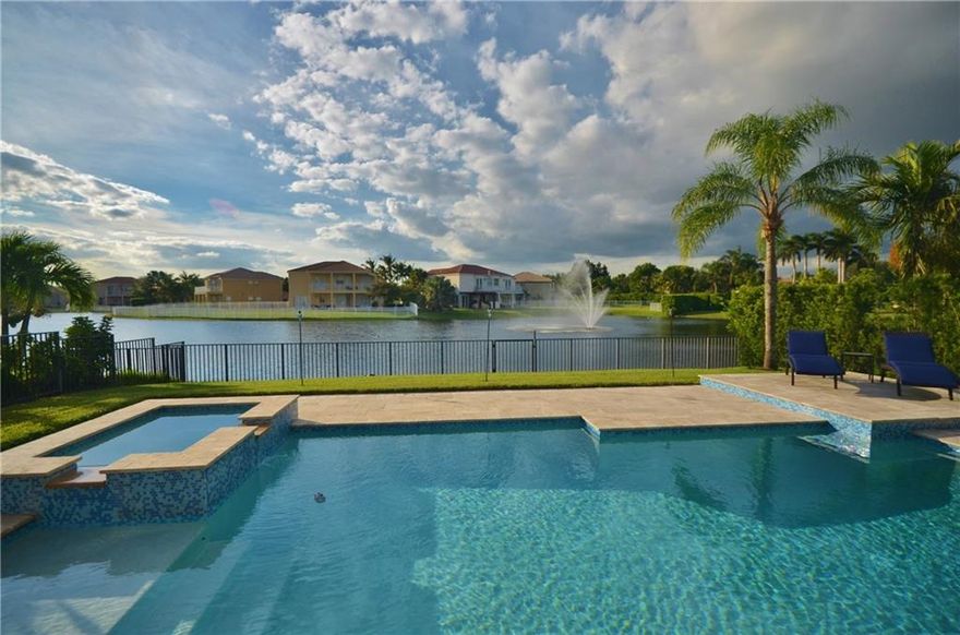 IMPACT WINDOWS & SLIDERS!! Wow...Run don't walk to preview this gorgeous home...shows like a new model! Fully upgraded features a heated pool, and a fountain, strategically placed on your Lake view! This popular model offers a bright, open floor plan. Stunning wrought iron banister takes you to the Master Bedroom with sitting room & luxury bath, and 2nd/3rd full sized bedrooms. All baths fully renovated. Downstairs 4th, with pool access, open as an office. 24/7 Man gated...Great Rec Club...Great Home!!