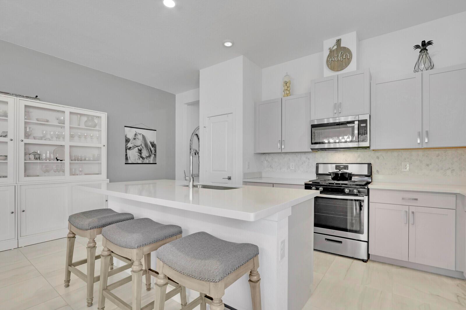 Discover one of the best values in all of the western communities! This popular open concept home with 10-foot ceilings shows like a model! The layout includes 3 bedrooms as well as a versatile den that's perfect for an office or playroom. New smart home technologies include WIFI and controls for alarms, cameras, thermostat, locks, lights, and garage door. Step outside to a covered patio overlooking a lush, open backyard on a large grass preserve. Arden may have the best amenity package in South Florida for the price. This guard gated community covers all the landscaping so you can enjoy the resort pools, fitness center, trails, courts, fields, lakes, and even a full calendar of planned activities. Finally, you even get a share from the organic farm. Check it out today!