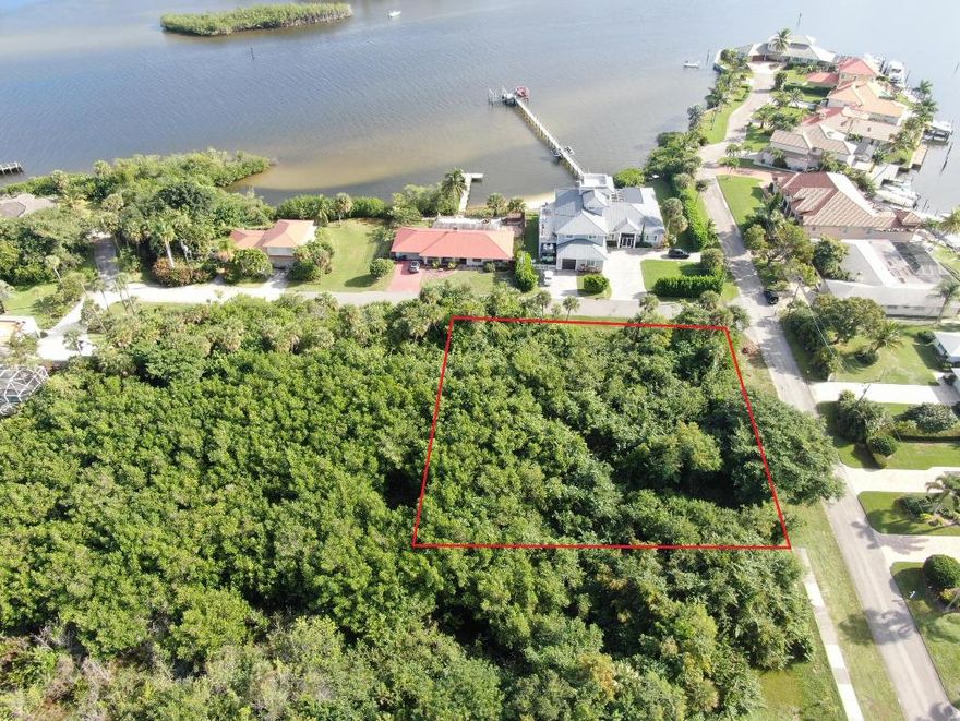 Panoramic water views await! Build your custom two or three story dream home on this beautiful 0.61 acre corner lot in the highly desirable neighborhood of Rocky Point. Situated across the street from the intracoastal on a very quiet and peaceful dead-end street with almost zero traffic, you'll be minutes away from public boat ramps, shopping, I-95, and some of the best schools in Florida! You can use the approved existing approximately 4,300 sq ft building pad or work with your builder to fill and expand.  Bldg. app. requires a wetland waiver. Wetland determination completed and available for serious buyers. 
There is No HOA. 
Don't miss the opportunity to own one of the last buildable lots with water views in Rocky Point!