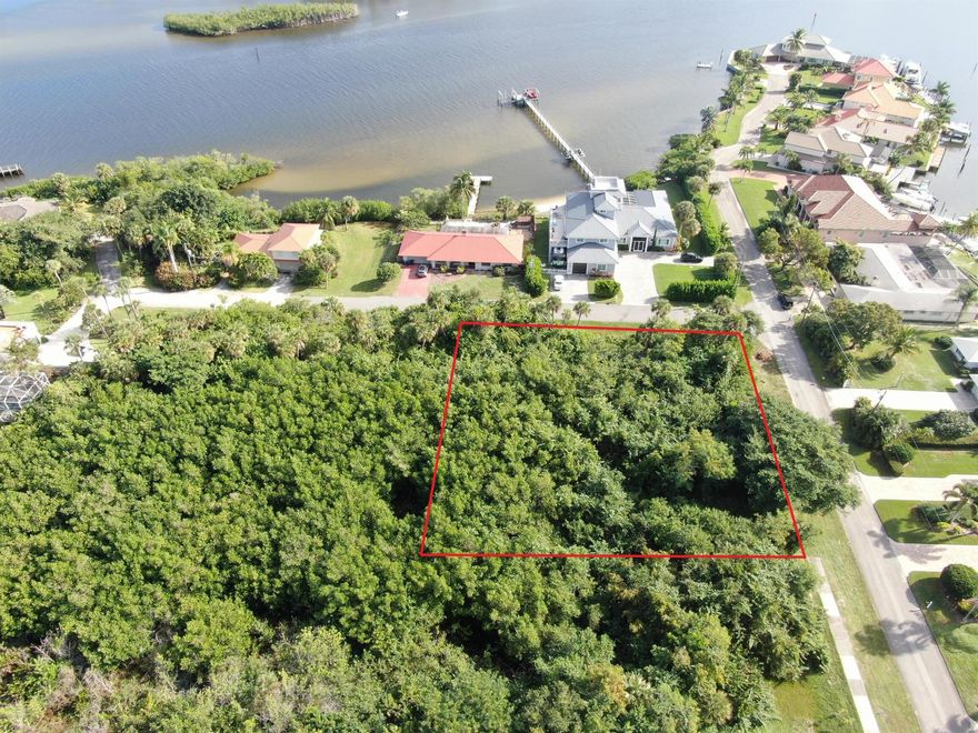 Panoramic water views await! Build your custom two or three story dream home on this beautiful 0.61 acre corner lot in the highly desirable neighborhood of Rocky Point. Situated across the street from the intracoastal on a very quiet and peaceful dead-end street with almost zero traffic, you'll be minutes away from public boat ramps, shopping, I-95, and some of the best schools in Florida! You can use the approved existing approximately 4,300 sq ft building pad or work with your builder to fill and expand.  Bldg. app. requires a wetland waiver. Wetland determination completed and available for serious buyers. There is No HOA. Don't miss the opportunity to own one of the last buildable lots with water views in Rocky Point!