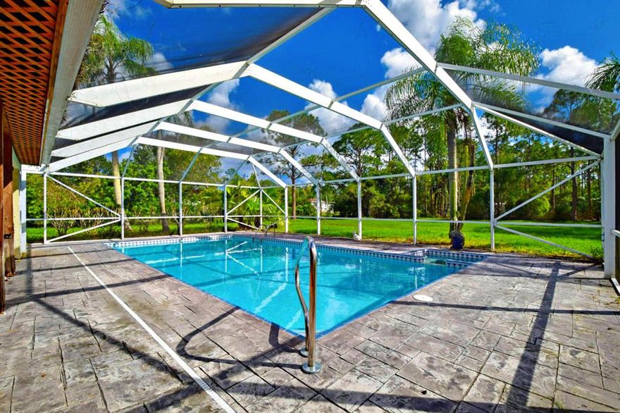 Presenting a tastefully renovated CBS Pool home in the highly desirable Jupiter Farms community. As you enter this life tested 3 bedroom 2 bathroom 2095 sqft floor plan you will feel as though you have entered your own private cabin in the woods. The wood design family room with a stone fireplace sets the mood in this lovely residence. As you make your way into the renovated kitchen you will find light oak cabinets with color match granite counters. The kitchen comes equipped with white appliances and an open dining room. Enjoy the pool view as you serve yourself a drink at your full size wet bar. Privacy is a must on your huge 1.25 acre fenced in corner lot with gated entry. Freshly painted and ready for a quick move in. Jupiter Farms is close to all you need and far from all you don't.