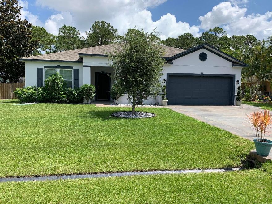 3 bedroom, 2 bath, 3 car garage, CBS home with den/office possible 4th bedroom.  The home is located in a desirable location close to schools, shopping, I95, turnpike, hospital, and local beaches.  The home features tile and laminate flooring throughout, tray ceiling in master, granite counter-tops, upgraded cabinets, pantry, plantation shutters, fenced yard, fruit trees, large, covered lanai, extended patio, shed, and backs up to a drainage canal for added privacy.  Don't miss this one!!